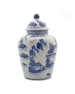 Dekor Deluxe porcelanasto bela vaza s pokrovom poslikana z modrimi motivi azijske pokrajine, ki jo na vrhu pokrova krasi temno modra konica.