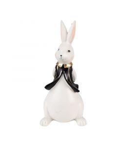 Figura belega velikonočnega zajčka v črnem brezrokavniku z zlatim ovratnikom in rokami za hrbtom